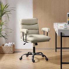 an office chair sitting on top of a hard wood floor next to a computer desk