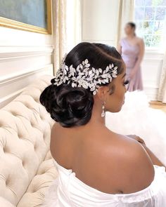 a woman in a wedding dress wearing a tiara