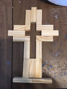 a wooden cross sitting on top of a table