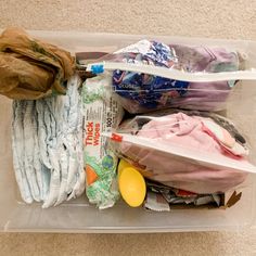 a plastic container filled with clothing and other items