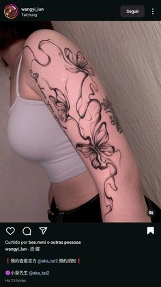 a woman's arm with flowers and butterflies tattooed on the back of her shoulder