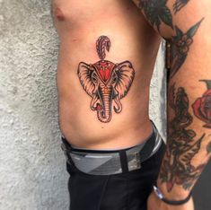 an elephant tattoo is on the side of a man's lower body and chest