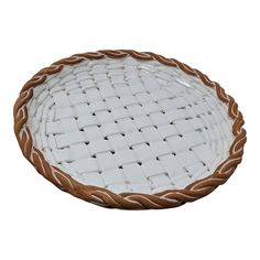 a white and brown basket sitting on top of a table