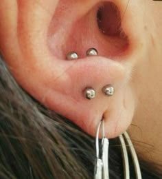 a woman with three piercings on her ear