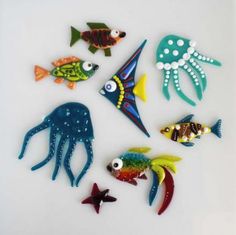 an assortment of sea animals on a white surface