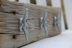 an old wooden bench with metal nails on it