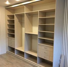 an empty walk in closet with shelves and drawers