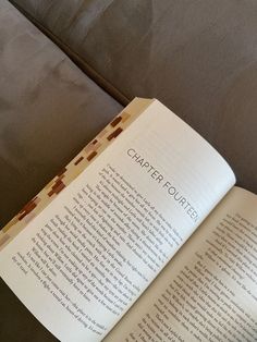 an open book sitting on top of a couch