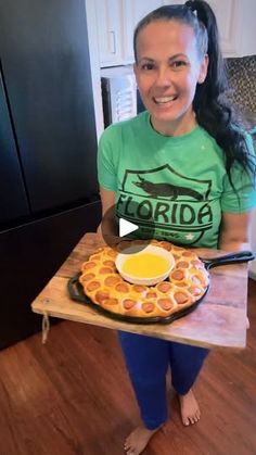 a woman holding a tray with some food on it