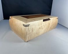 a wooden box sitting on top of a white floor