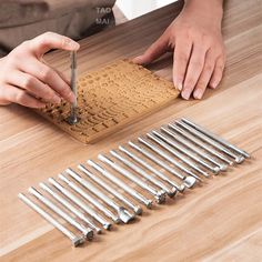 a person is working with tools on a wooden table