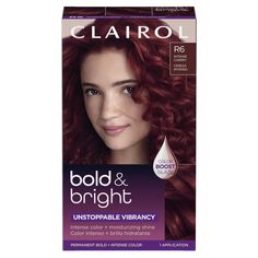 the front of a box of clairol hair color and brightening kit with red curly hair