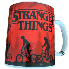 a coffee mug with the words, strange things on it and a silhouette of a man riding a bike