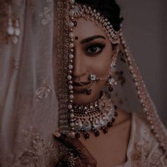 a woman wearing a bridal veil and jewelry