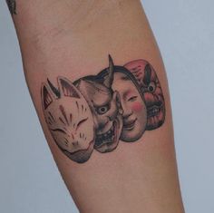 an arm with three masks on it and one has a cat, two are wearing masks