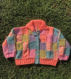 a sweater that is laying on the grass