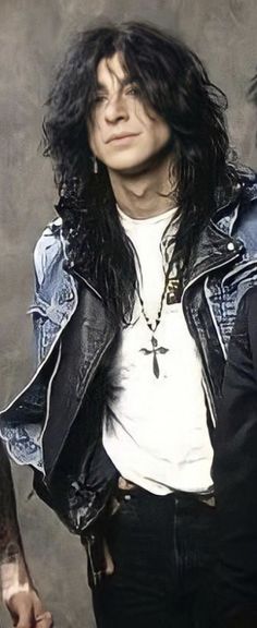 a man with long hair wearing a leather jacket