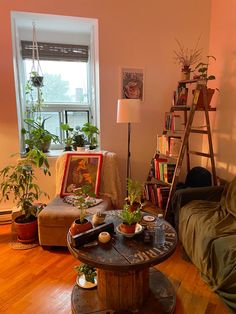 a living room filled with furniture and lots of plants on top of a wooden table