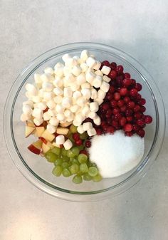 grapes, apples, and marshmallows in a glass bowl