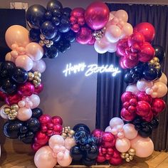 a happy birthday balloon arch with balloons