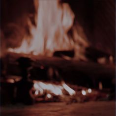 a blurry photo of a fire burning in a fireplace