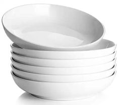 a stack of white bowls sitting on top of each other