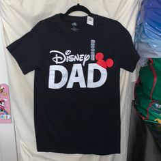 Disney Dad Shirt. Measurements Shown In Pics. Sz Small Men's Black Disney T-shirt For Disney Trips, Mom And Dad Disney Shirts, Casual Black Shirt For Disney Trips, Black Pre-shrunk T-shirt For Disney Trips, Graphic Tee For Disney Trips In Black, Black Graphic Tee For Disney Trips, Black Mickey Mouse Shirt For Disney Fan Events, Black Disney Cotton Shirt, Black Cotton T-shirt For Disney Trips