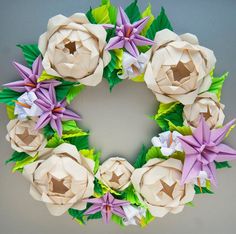 a wreath made out of paper flowers and leaves