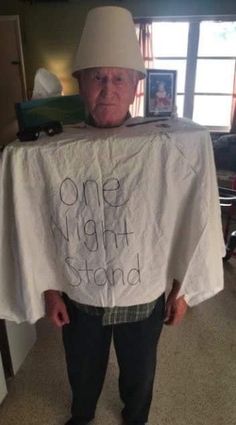 an older man wearing a white shirt with the words one night stand written on it