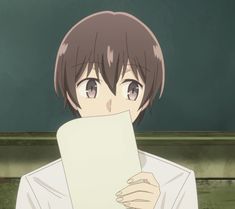 an anime character holding a piece of paper in front of his face and looking at the camera