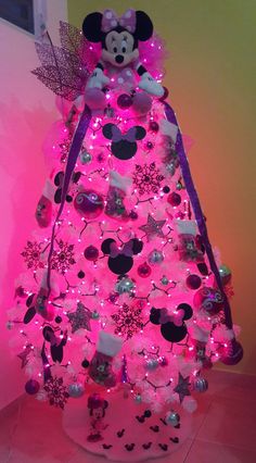 a pink christmas tree with minnie mouse decorations