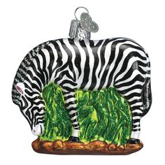 a glass ornament depicting two zebras eating grass