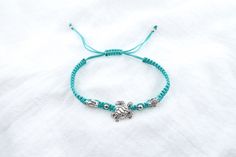 This Turtle Bracelet with a nylon cord is adjustable and handmade. Fully waterproof and won't slip off, it's a great gift for kids! Adjustable Sliding Knot Nylon Thread Bracelets, Handmade Adjustable Friendship Bracelets In Nylon, Adjustable Turquoise Friendship Bracelets For Summer, Handmade Adjustable Nylon Cord Friendship Bracelets, Adjustable Turquoise Braided Bracelet For Beach, Casual Turquoise Braided Bracelet With Sliding Knot, Casual Turquoise Braided Bracelets For Gift, Blue Nylon Cord Friendship Bracelets For Beach, Handmade Adjustable Turquoise Friendship Bracelets