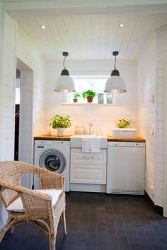 a washer and dryer sitting in a room next to each other with lights on