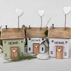 three small houses with hearts on the roof