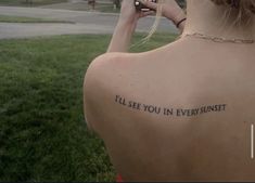 the back of a woman's neck with an inscription on it that reads, i'll'll see you in every sunset