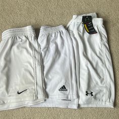 Adidas And Nike Pairs Are Women's Small, Under Armour Pair Is Men's Size Small. Each Pair Is Listed Individually In My Closet-- Check Out Each Listing For More Details Or To Buy A Single Pair Adidas: Never Worn To Play, Just Tried On And Didn't Fit! Size S But Could Fit A Small Or Medium In My Opinion! Nike: Gently Used- Small Dots/Stains As Seen In The Pictures, But They Really Can't Be Seen From Afar. Under Armour: Brand New, With Tags Attached Adidas White Athletic Shorts With Moisture-wicking, Adidas Sporty White Athletic Shorts, White Adidas Sports Shorts, Adidas White Sporty Shorts, Adidas White Sports Shorts, Adidas White Cotton Athletic Shorts, Adidas White Summer Bottoms, White Adidas Bottoms For Summer, Adidas White Casual Shorts