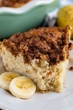 a slice of banana coffee cake on a plate with a fork and bowl in the background