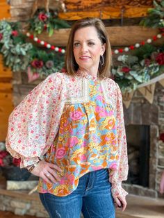 Look blooming fabulous in this Grace Multi-Floral Blouse! From the frill mock neck to the sheer bubble sleeves, this playful top will have you living your best floral fantasy. Plus, the smocked cuffs provide a flattering and comfortable fit. Get ready to brighten up the room! Relaxed fit. I am in the small. You can size down. Sizes: Small-Large 100% Rayon Follow tag instructions for washing. Flowy Smocked Top For Spring, Feminine Fall Smocked Top With Floral Print, Feminine Floral Smocked Top For Fall, Pink Floral Print Smocked Long Sleeve Top, Pink Floral Print Smocked Top With Long Sleeves, Pink Floral Print Long Sleeve Smocked Top, Pink Bishop Sleeve Blouse For Spring, Chic Smocked Lantern Sleeve Top For Spring, Spring Bishop Sleeve Blouse With Elastic Sleeves