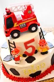 a birthday cake for a five year old boy with a fire truck on the top