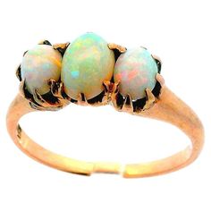 This is a gorgeous, 1910 Edwardian, 14k yellow gold and opal ring. This ring is very unique, featuring three cabochon cut opals with excellent body color. The wide range of body color provides a beautiful layer of sparkle, and also allows for this ring to be worn with an array of colors and outfits. Though this ring is perfect for daily wear, it is also sophisticated enough to be worn to formal occasions, and matches a black or white dress excellently. Opal has long been considered as a symbol o Black Opal Jewelry, Yellow Gold Opal Ring, Opal Ring Gold, Body Color, Stone Design, Opal Ring, Black Opal, Opal Jewelry, Jewelry Rings Engagement