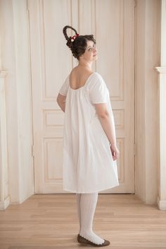 "A Regency Chemise or a shift creates a needed layer between your body and the corset. Made from a white semi-sheer cotton lawn it is perfect for your Jane Austen Era costuming needs. It also suits as a lower layer for your Bridgerton inspired look. The shift is sewn according to historically accurate period undergarments recommendations . That is why it has: - a gusseted underarm that enables your arm movement; - short sleeves; - the drawstring that adjusts the neckline, so you can feet your de Regency Era Nightgown, Regency Nightgown, Regency Chemise, Regency Short Stay, Regency Underdress, Regency Chemise Pattern, Womens Lingerie, Bridgerton Inspired, Regency Period