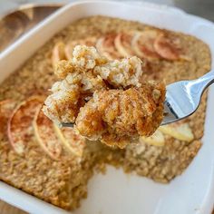 a spoonful of oatmeal is being lifted from a casserole dish