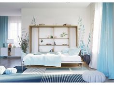 a white bed sitting in a bedroom on top of a blue carpeted floor next to a book shelf