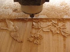 a wood carving is being worked on with a driller and sandblading tools