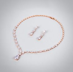 A beautiful two-piece bridal jewelry set with an incredible sparkle! Adorned with intricately faceted cubic zirconia that capture the light from every angle with a perfectly translucent appeal, the pieces are platinum / rose gold / yellow gold plated for a flawless finish which enhances the intricate detailing and conveys a modern take on old elegance. Necklace: 16.75" (approx. 42.5cm) long, with a secure fold-over closure. If longer is needed, please leave a note at checkout with your desired l Elegant Rose Gold Jewelry Sets With Diamond Accents, Formal Rose Gold Jewelry Sets With Diamond Accents, Formal Rose Gold Crystal Jewelry Sets, Rose Gold Wedding Jewelry Sets With Diamond Accents, Elegant Rose Gold Bridal Sets With Brilliant Cut, Rose Gold Cubic Zirconia Bridal Set For Wedding, Bridal Jewelry Set, Platinum Rose Gold, Cz Jewelry