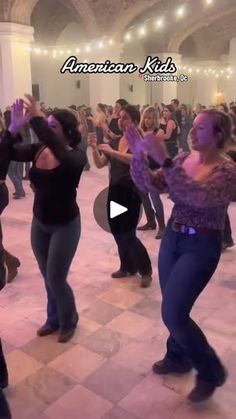 a group of people dancing in a large room