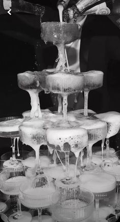 an image of someone pouring water into cups