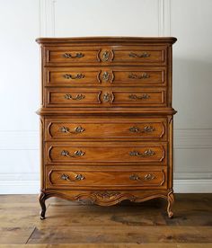 an old wooden dresser sitting on top of a hard wood floor