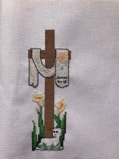 the cross is made out of fabric and has an image of a cow on it